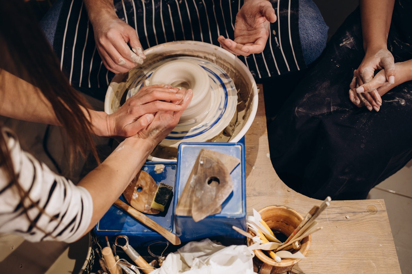 Hands together make ceramics pregnant girl with a man